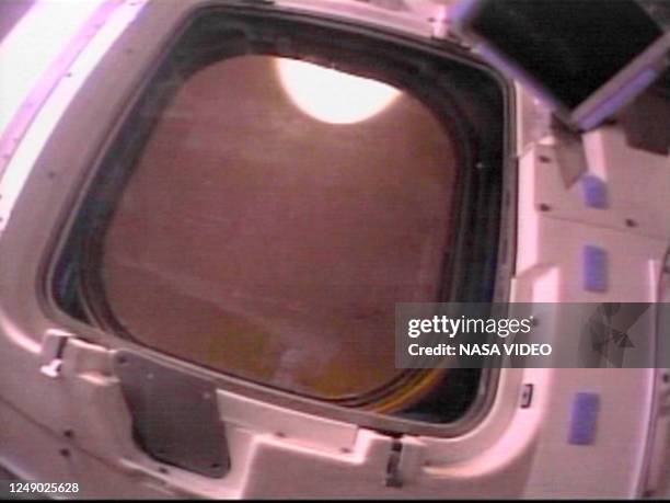 This photo released by NASA shows a view through one of space shuttle Columbia's overhead windows with a plasma flash 01 February 2003 as captured by...