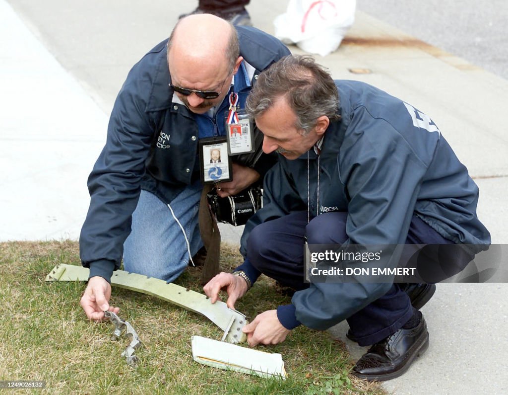 Faa Inspector Federal Aviation Authority inspectors look at small pieces of plane ...