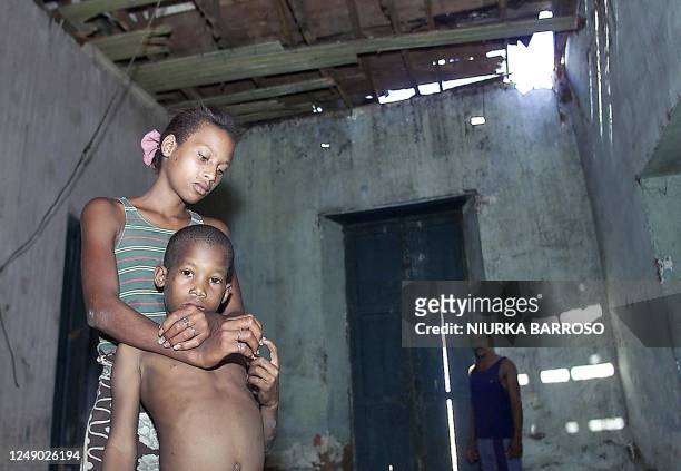 Kensy Tejera holds her son Yansier Garvey in La Habana, Cuba 22 March 2002. W Kensy Tejera , junto a su hijo Yansier Garvey , muestran las...