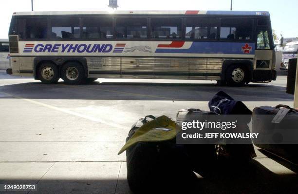 An empty Greyhound bus pulls into the Greyhound Bus Terminal as luggage sits on the curb in Detroit after Greyhound suspended bus service 03 October...