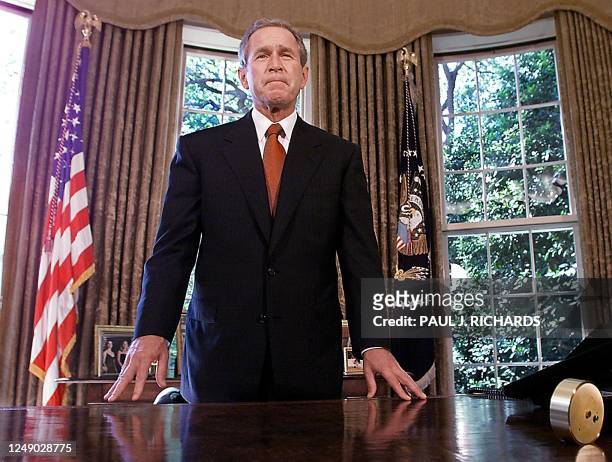 President George W. Bush stands in the Oval Office of the White House after making a phone call to New New York City Mayor Rudolph Giuliani and New...