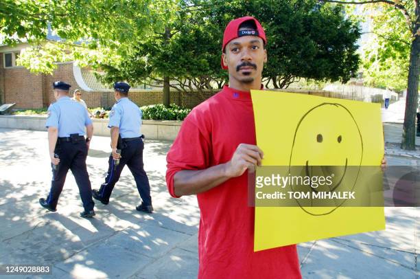 Dave Clements, of Ardencroft, Delaware, holds a poster with the smile face near the Liberty Bell in Philadelphia PA ,12 September 2001. Clements said...