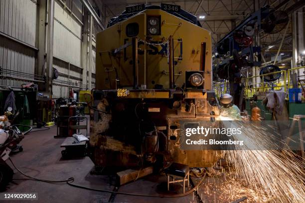 Welder works on a locomotive engine at the CSX Waycross Service Center in Waycross, Georgia, US, on Tuesday, Feb. 21, 2023. CSX has been one of the...