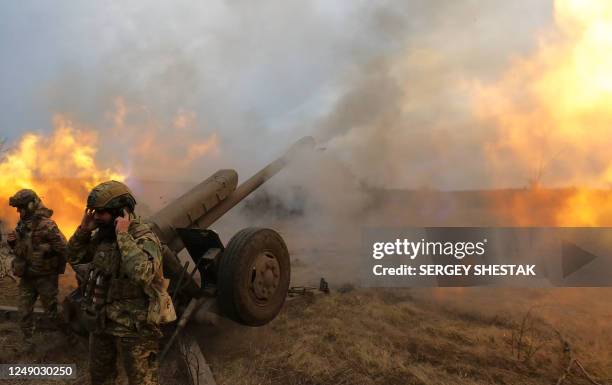 This still image taken from a footage by AFP shows Ukrainian servicemen firing with a D-30 howitzer at Russian positions near Bakhmut, eastern...