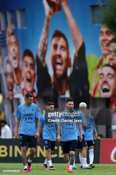 Angel Di Maria and Lionel Messi of Argentina gesture during a training session at Julio H. Grondona Training Camp on March 21, 2023 in Ezeiza,...