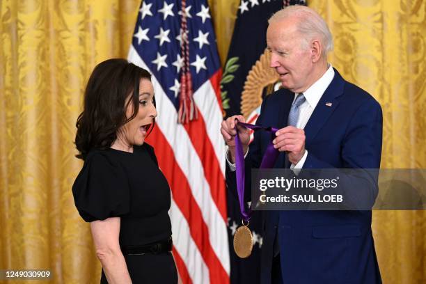 President Joe Biden awards actress Julia Louis-Dreyfus with the 2021 National Medal of Arts during a ceremony in the East Room of the White House in...