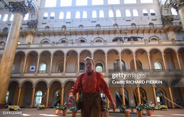 French high-wire artist Philippe Petit makes preparations ahead of his performance in the Great Hall of the National Building Museum in Washington,...