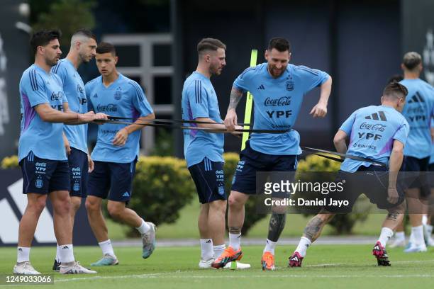 Guido Rodriguez, Alexis Mac Allister, and Lionel Messi of Argentina in action during a training session at Julio H. Grondona Training Camp on March...