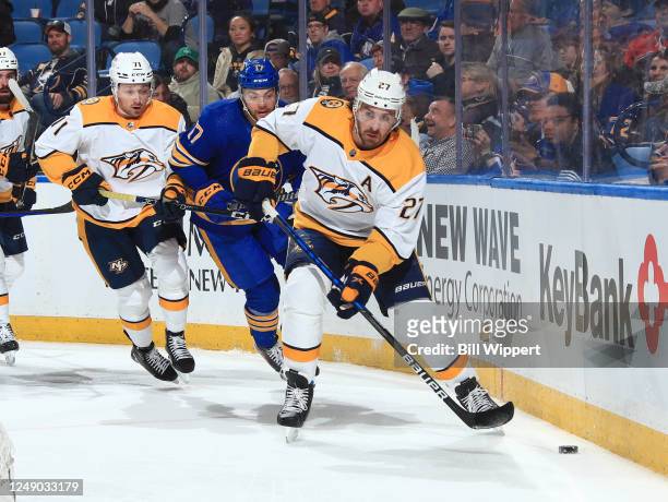 Ryan McDonagh of the Nashville Predators controls the puck against Tyson Jost of the Buffalo Sabres during an NHL game on March 21, 2023 at KeyBank...