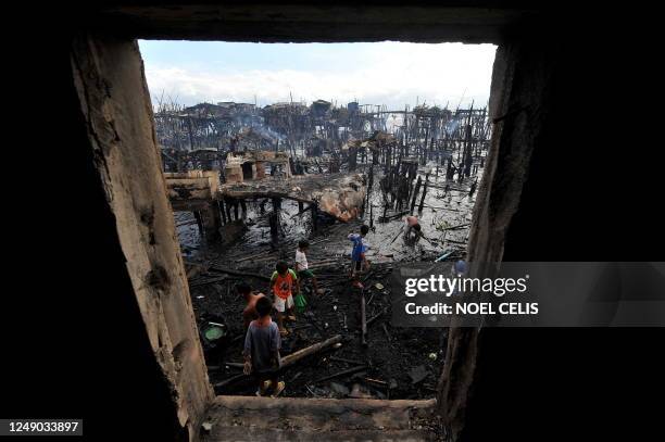 General view shows the aftermath of a fire which gutted a sprawling shanty town at the bay of Navotas, Manila on August 27, 2010. Some 200 homes were...