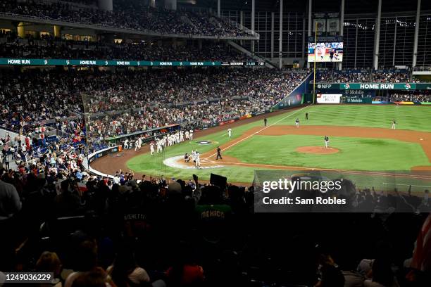 Munetaka Murakami of Team Japan is greeted at home plate after hitting a solo home run in the second inning during the 2023 World Baseball Classic...