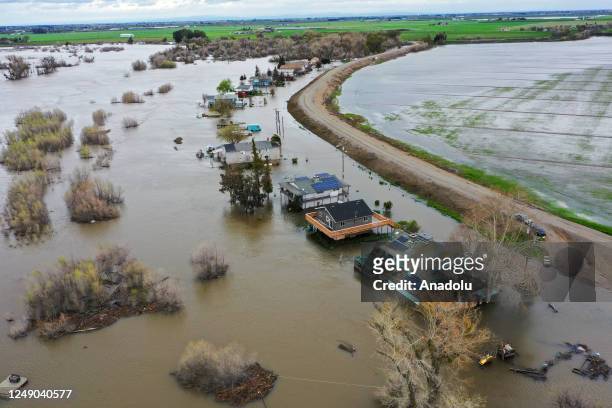 An aerial view shows homes under water after levee fails in Manteca of San Joaquin County in California, United States on March 21, 2023 as...