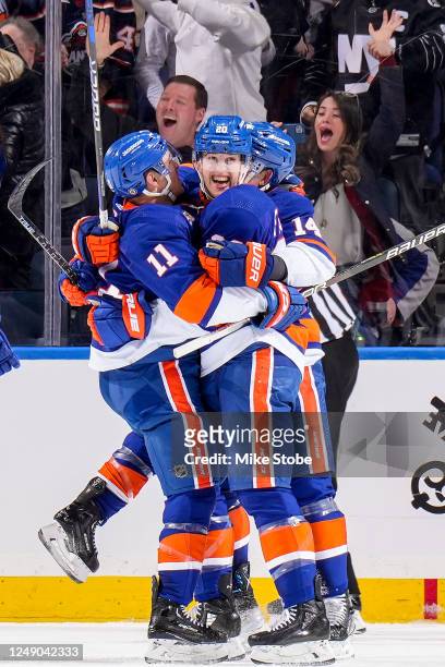 Hudson Fasching of the New York Islanders is congratulated by his teammates after scoring a goal against the Toronto Maple Leafs during the second...