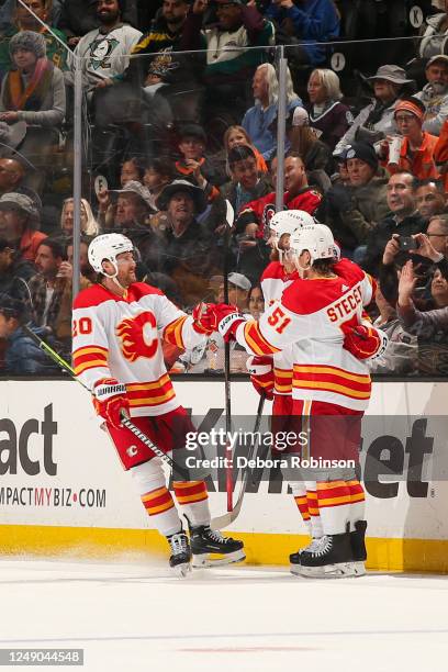 Troy Stecher of the Calgary Flames celebrates his goal with teammates during the first period against the Anaheim Ducks at Honda Center on March 21,...