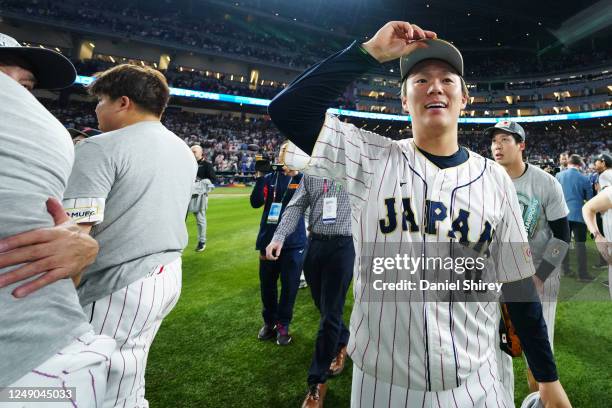 Shohei Ohtani of Team Japan celebrates with teammates after a 3-2 victory over Team USA in the 2023 World Baseball Classic Championship game at...