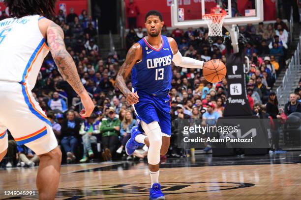 Paul George of the LA Clippers dribbles the ball during the game against the Oklahoma City Thunder on March 21, 2023 at Crypto.Com Arena in Los...