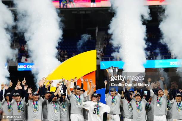 Shohei Ohtani of Team Japan holds the World Baseball Classic Championship trophy on stage as Team Japan celebrates their 3-2 victory over Team USA in...