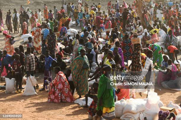 Internally displaced women wait at the food distribution center as they receive their monthly food rations distributed by the World Food Programme in...