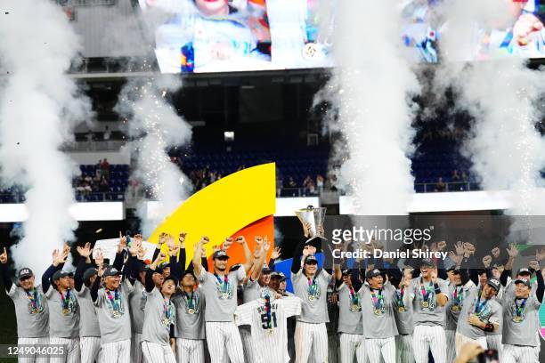 Shohei Ohtani of Team Japan holds the World Baseball Classic Championship trophy on stage as Team Japan celebrates their 3-2 victory over Team USA in...