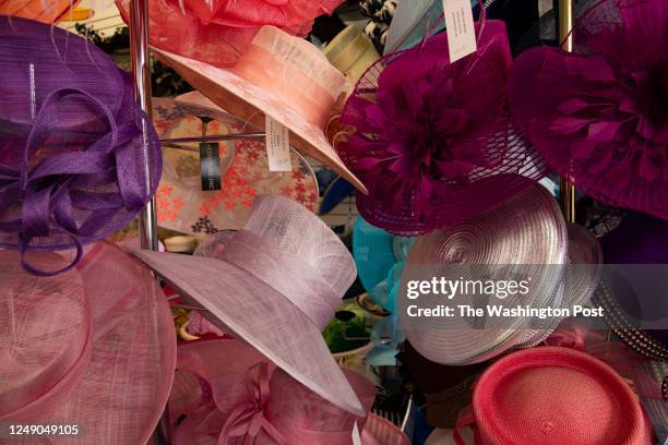 Hats hang on racks at Tops of Old Town, famed hat shop in the Del Ray neighborhood, on March 14, 2023 in Alexandria, VA. Del Ray has been revitalized...