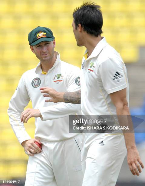 Australian captain Michael Clarke and Mitchell Johnson interact during the fourth day of the second Test match between Australia and Sri Lanka at the...