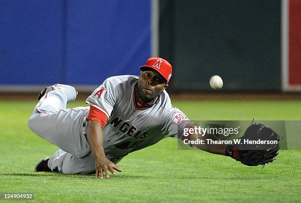 Torii Hunter of the Los Angeles Angels of Anaheim dives but can't make the catch of this ball that goes for an RBI double off the bat of Josh...