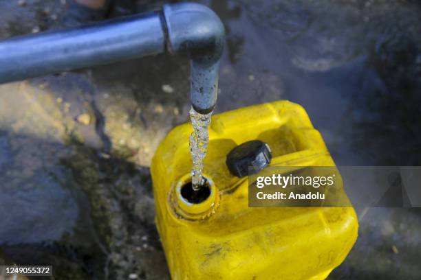 Boy fills plastic bottles with water from a water well during the World Water Day, which 22 March of each year was declared by United Nations in...