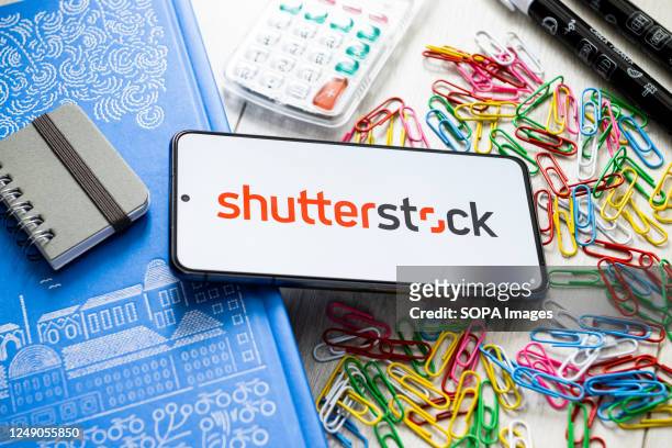In this photo illustration a Shutterstock logo seen displayed on a smartphone.