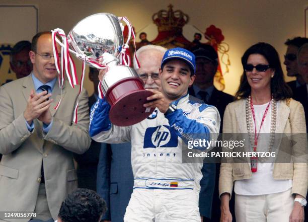 Colombian BMW-Williams driver Juan Pablo Montoya , flanked by Prince Albert , Princess Caroline and their father Rainier III of Monaco, holds his...