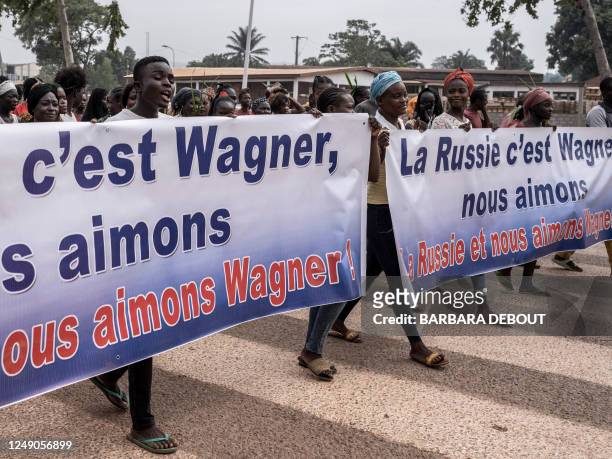 Demonstrators carry banners in Bangui, on March 22, 2023 during a march in support of Russia and China's presence in the Central African Republic. -...