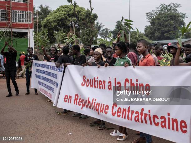 Demonstrators carry banners in Bangui, on March 22, 2023 during a march in support of Russia and China's presence in the Central African Republic. -...