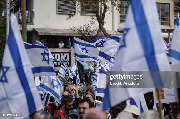 People carrying Israeli flags and banners gather outside the Eretz Israel Museum to protest against regulations of Prime Minister of Israel Benjamin...