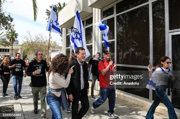 People carrying Israeli flags and banners gather outside the Eretz Israel Museum to protest against regulations of Prime Minister of Israel Benjamin...