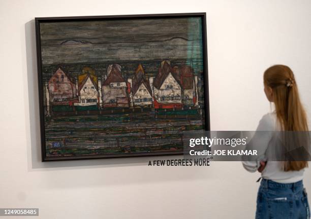 Visitor looks at the tilted painting Houses by the Sea by Eugon Schiele, on March 22,2023 at the Leopold Museum in Vienna. - Gustav Klimt's...