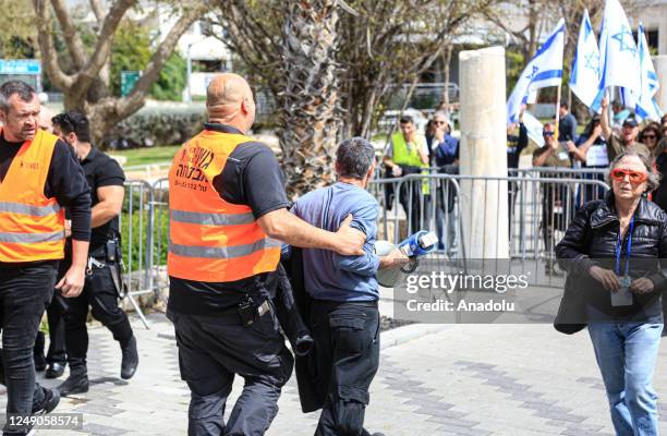 People carrying Israeli flags and banners gather outside the Eretz Israel Museum to protest against regulations of Prime Minister of Israel Benjamin...