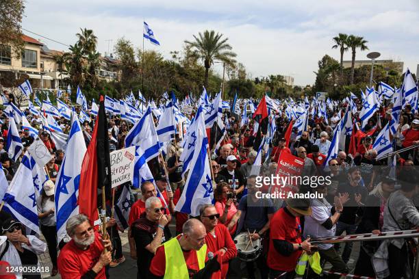 People carrying Israeli flags and banners gather outside the Eretz Israel Museum to protest against regulations of Prime Minister of Israel Benjamin...
