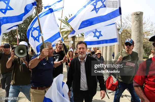 People carrying Israeli flags and banners gather outside the Eretz Israel Museum to protest against regulations of Prime Minister of Israel Benjamin...