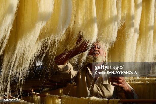 Worker dries vermicelli, which is used to make traditional sweet dishes popularly consumed during the holy month of Ramadan, at a factory in...