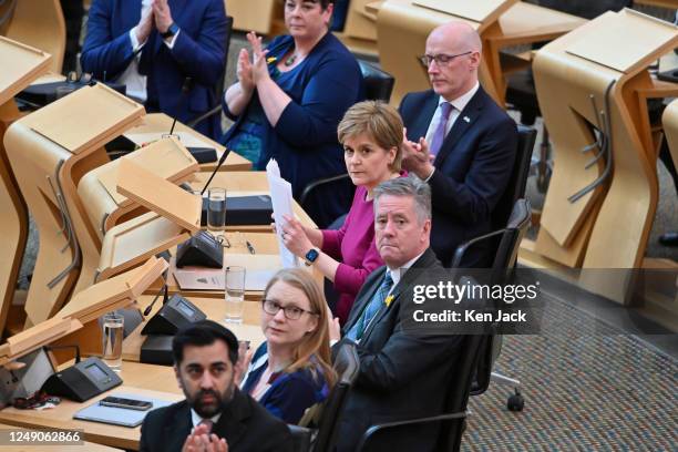 First Minister Nicola Sturgeon and front bench ministers turn to the public gallery of the Scottish Parliament, where a number of people who had...