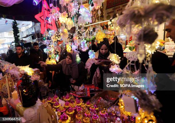 Palestinians shop for decorations in Al-Zawya old market in Gaza City, in preparation for the upcoming Muslim holy fasting month of Ramadan.