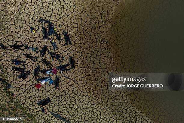 An aerial picture taken on March 22, 2023 shows activists laying on the dry soil during an environmental Global Climate Action demonstration, calling...