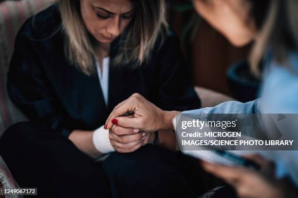 psychotherapist holding patient's hand - neuroscience stock pictures, royalty-free photos & images