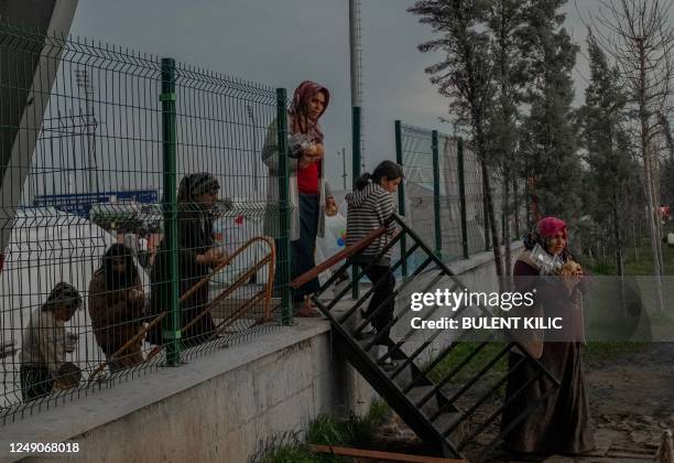 Displaced people walk back to the refugee camp after receiving a meal in Adiyaman, on March 22 following the 7.8-magnitude earthquake that hit the...