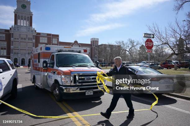 Police investigate at Denver's East High School after a shooting there on Wednesday, March 22, 2023. Police said a student shot two adult male...