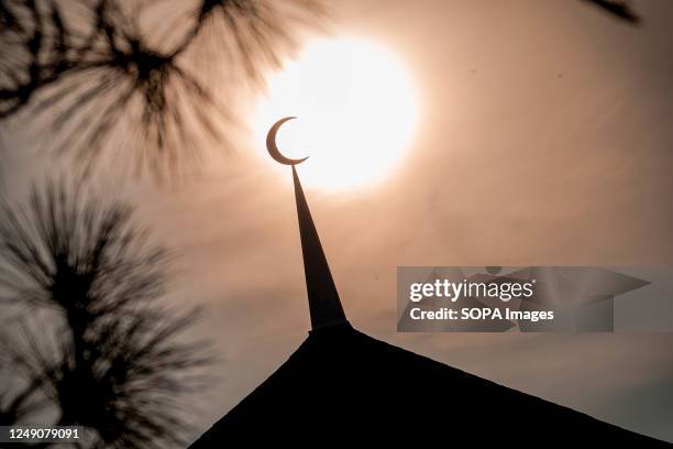 Silhouette of a replica crescent moon against the sun during a "rukyah", a moon sighting ceremony to determine the start date of the holy month of...