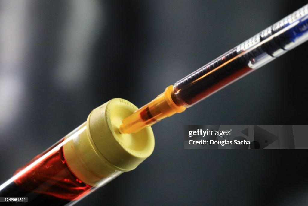 Syringe Being Inserted Into A Sealed Test Tube High-Res Stock Photo ...