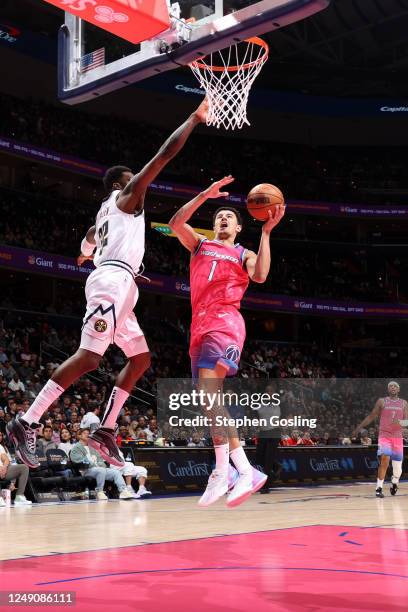 Johnny Davis of the Washington Wizards drives to the basket during the game against the Denver Nuggets on March 22, 2023 at Capital One Arena in...