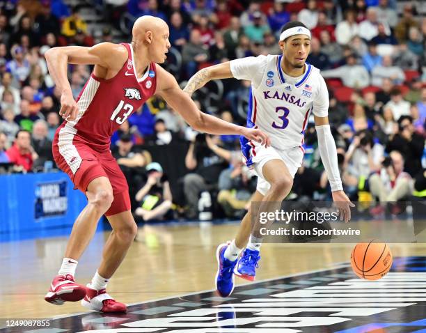 Kansas Jayhawks guard Dajuan Harris Jr controls the ball as Arkansas Razorbacks guard Jordan Walsh defends during the second round of the NCAA...