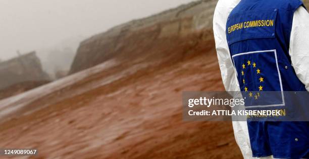 Hungarian specialists and EU experts walk on the ruptured reservoir wall of the aluminium plant near Ajka and the village of Kolontar on October 18,...