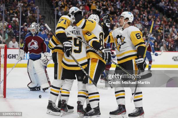 Jake Guentzel of the Pittsburgh Penguins celebrates a goal against the Colorado Avalanche with teammates Sidney Crosby and Evgeni Malkin at Ball...